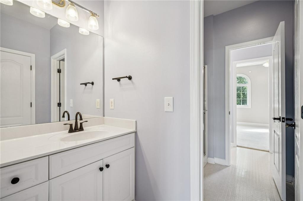 181 Granny Smith Circle Clarkesville, GA 30523 - Photo 54 of 79 a bathroom with a sink a vanity and a mirror