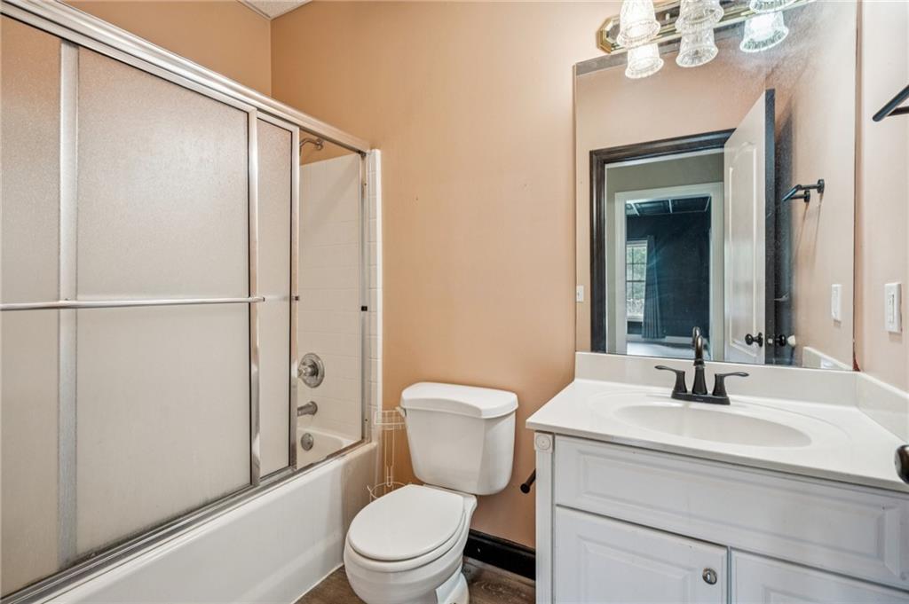 181 Granny Smith Circle Clarkesville, GA 30523 - Photo 59 of 79 a bathroom with a toilet a sink and a mirror