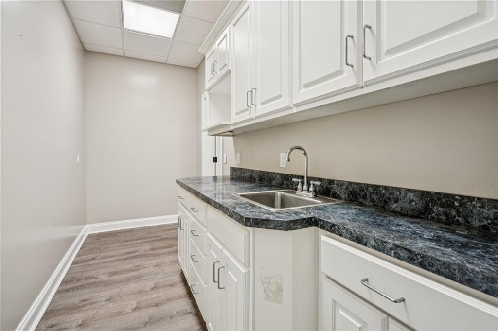 181 Granny Smith Circle Clarkesville, GA 30523 - Photo 65 of 79 a kitchen with granite countertop a sink and cabinets