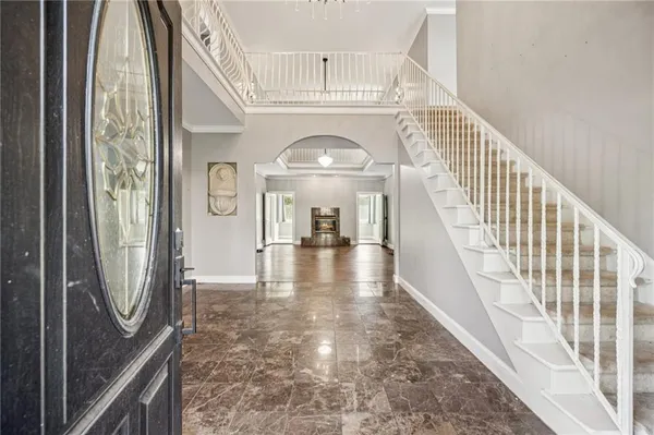 a view of an empty room with wooden floor fireplace and a window