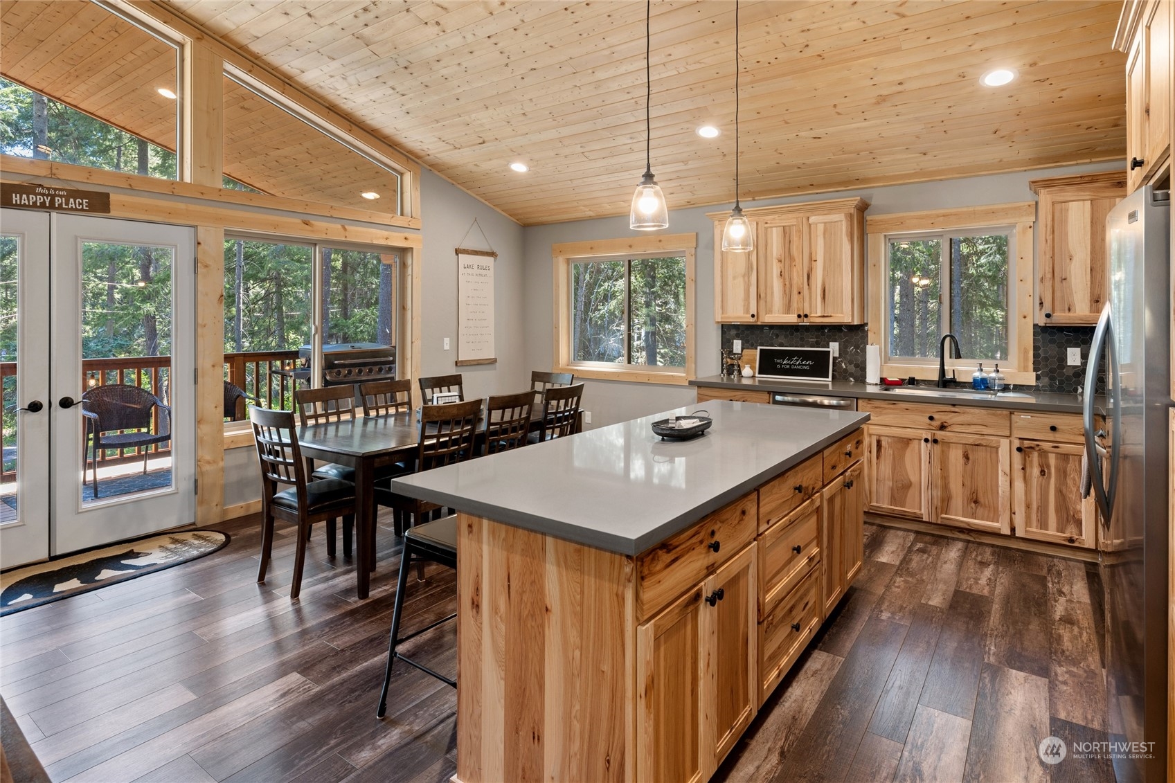 230 Easy Street Ronald, WA 98940 - Photo 11 of 40 a kitchen with stainless steel appliances granite countertop a stove a sink dishwasher and a dining table with wooden floor