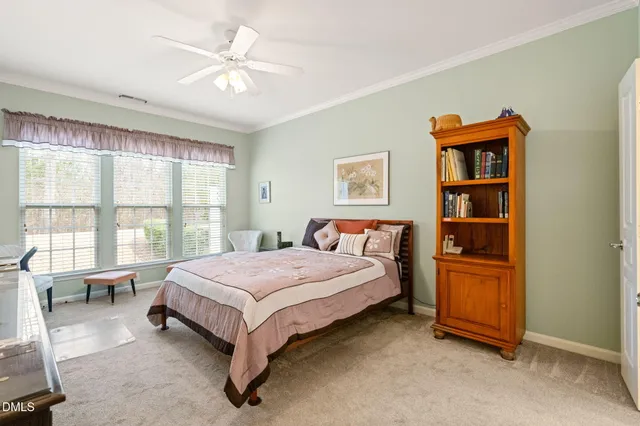 a spacious bedroom with a bed and a cabinets