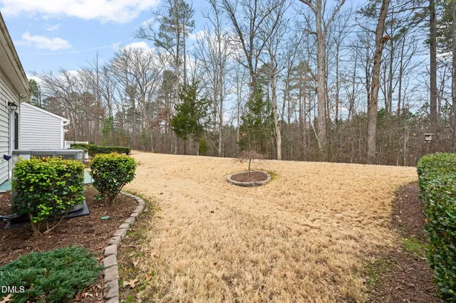 a living room with fireplace furniture and a large window