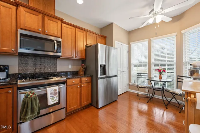 a kitchen with stainless steel appliances a stove a sink and a microwave