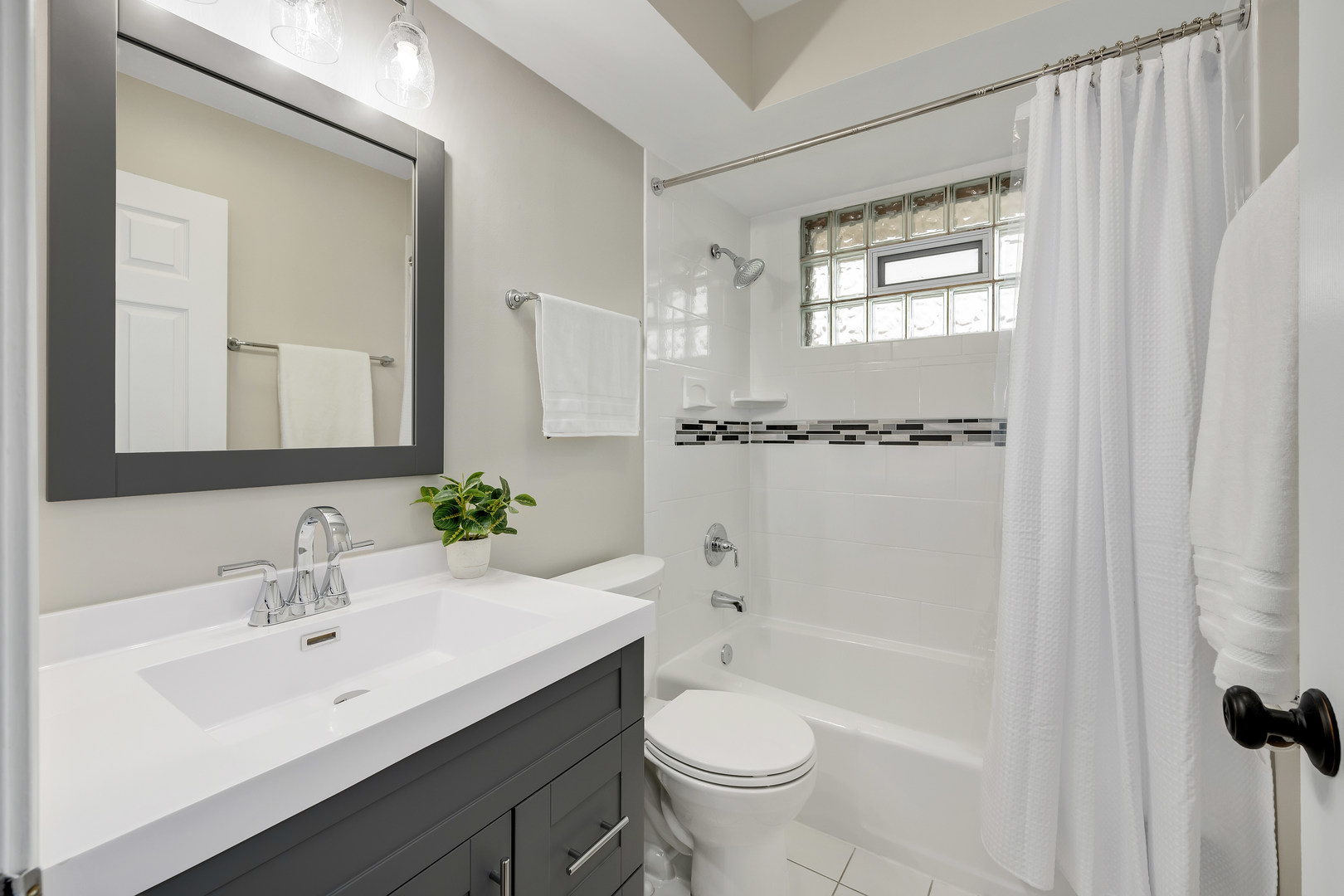 7804 Rohrer Drive Downers Grove, IL 60516 - Photo 16 of 28 a bathroom with a bathtub shower sink vanity and toilet