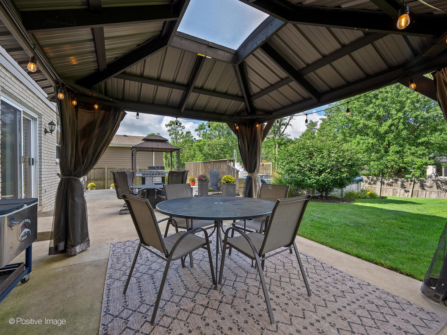 7804 Rohrer Drive Downers Grove, IL 60516 - Photo 26 of 28 a view of patio with table and chairs under an umbrella with a small yard