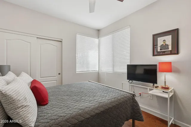 a bedroom with a bed and a flat screen tv