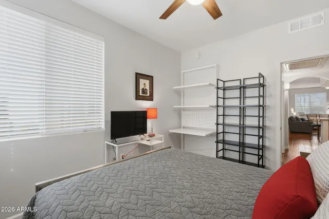 a bedroom with a bed and a flat screen tv