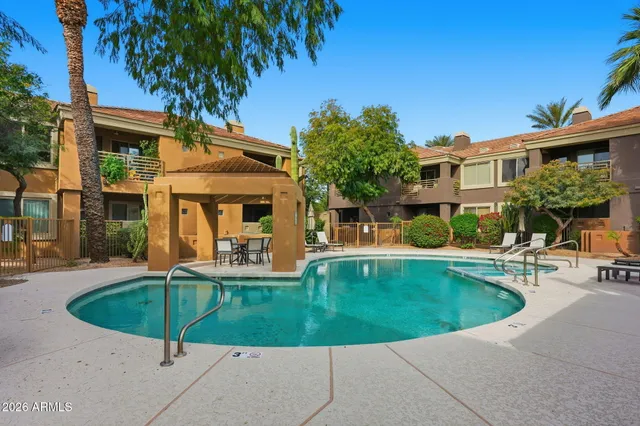 a view of a house with swimming pool and sitting area