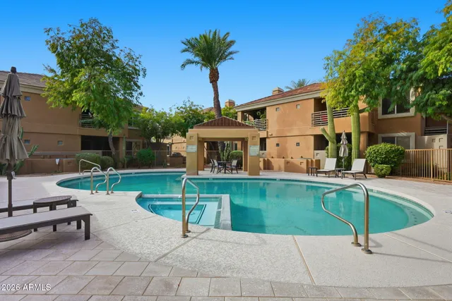 a view of a house with backyard porch and sitting area