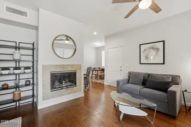 a living room with furniture a flat screen tv and a fireplace