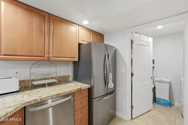 a kitchen with stainless steel appliances granite countertop a refrigerator and a sink
