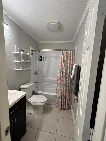 a bathroom with a sink a toilet a mirror and shower