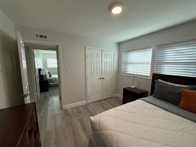 a view of a house with backyard and trees