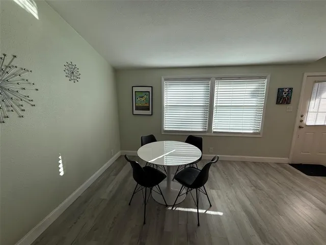 a view of a room with a table and chairs