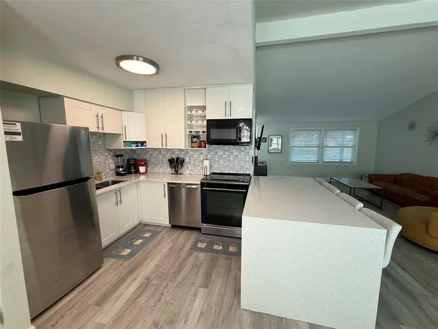 a kitchen with a stove a refrigerator and a sink