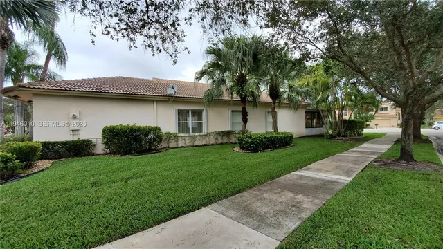 a front view of a house with a garden