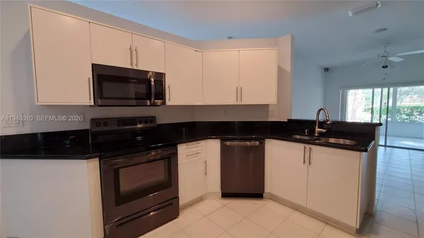 a kitchen with a sink and a stove top oven