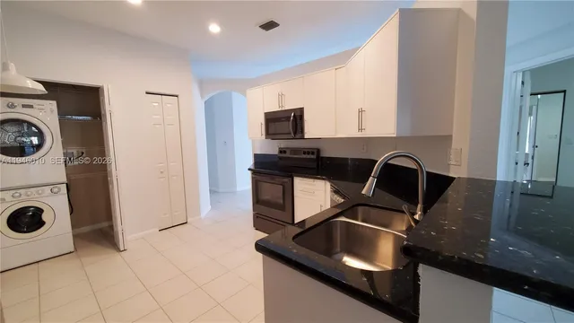 a kitchen with a sink and a stove top oven