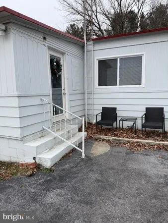 a view of house with backyard and seating area