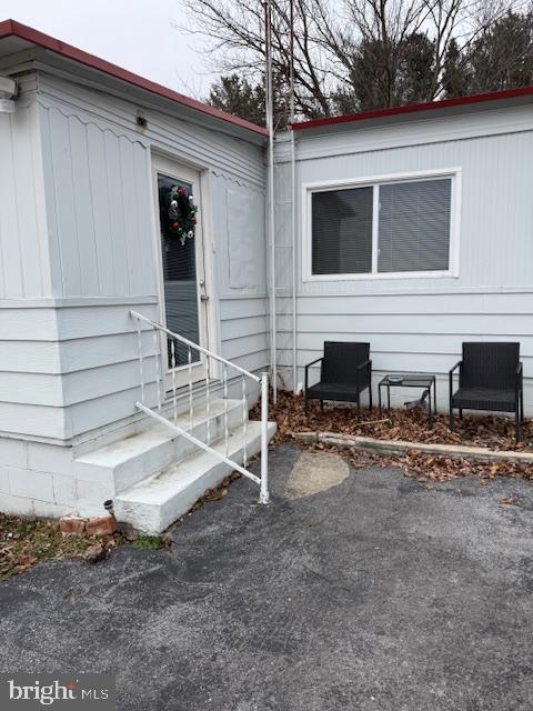 a view of house with backyard and seating area