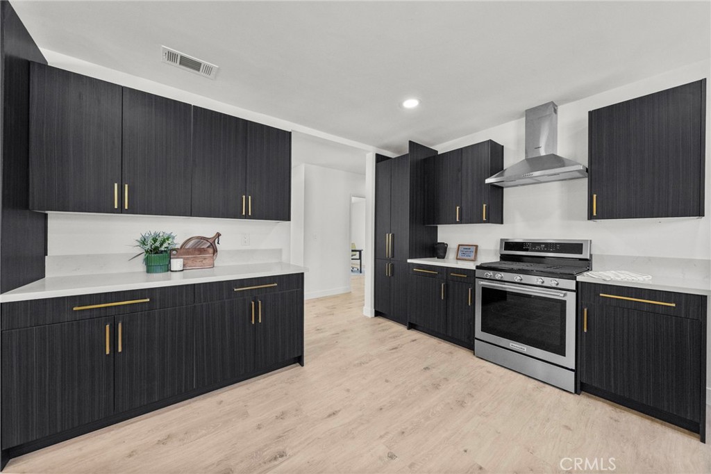4881 Arlington Avenue Riverside, CA 92504 - Photo 13 of 37 a kitchen with stainless steel appliances granite countertop a stove a sink and a refrigerator