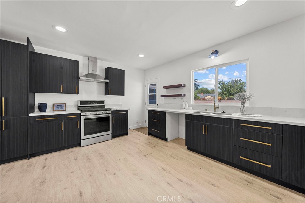 4881 Arlington Avenue Riverside, CA 92504 - Photo 15 of 37 a kitchen with stainless steel appliances kitchen island granite countertop a refrigerator and a sink
