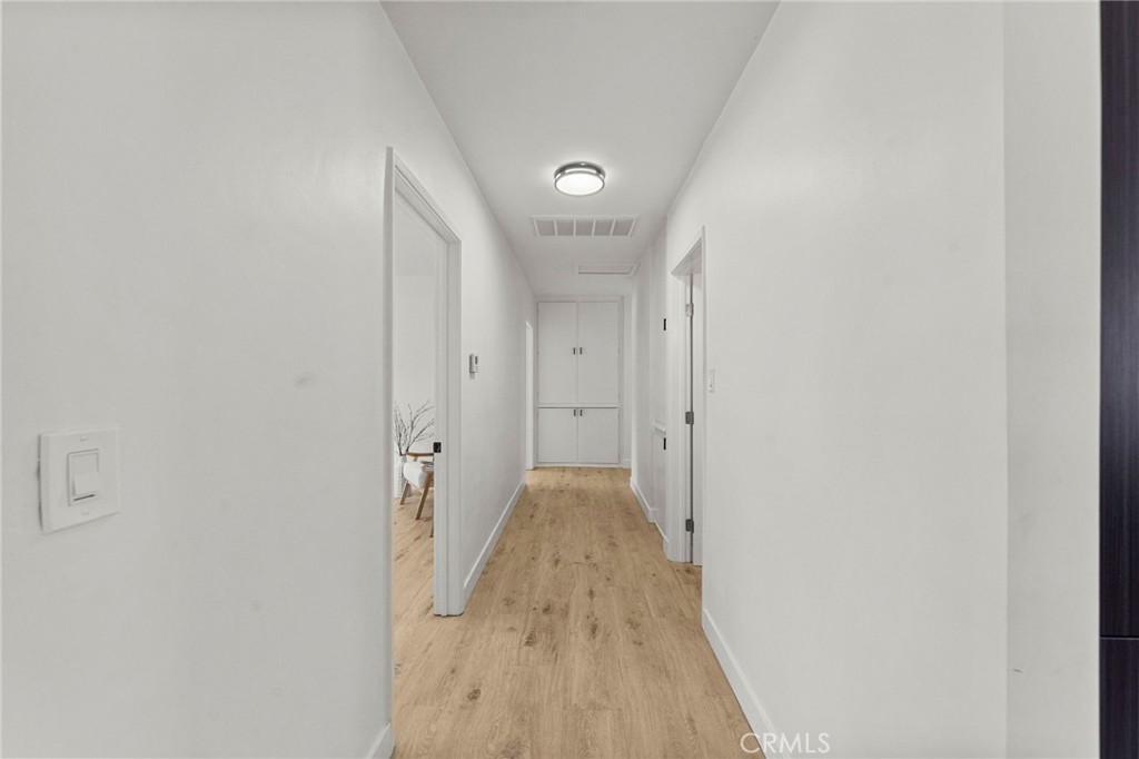 4881 Arlington Avenue Riverside, CA 92504 - Photo 18 of 37 a view of a hallway with wooden floor and a bathroom