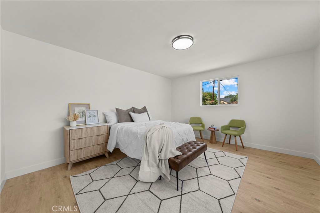 4881 Arlington Avenue Riverside, CA 92504 - Photo 19 of 37 a spacious bedroom with a bed and chair