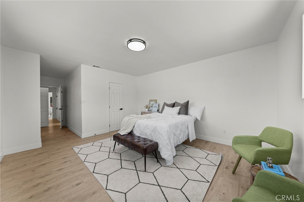 4881 Arlington Avenue Riverside, CA 92504 - Photo 20 of 37 a bedroom with a bed and a potted plant