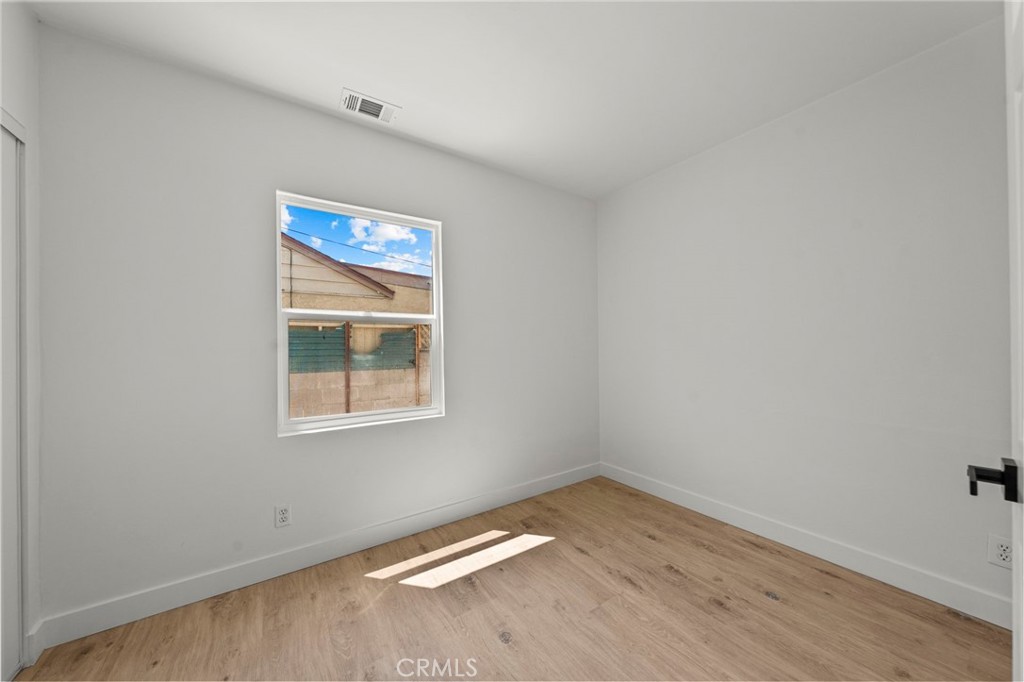 4881 Arlington Avenue Riverside, CA 92504 - Photo 27 of 37 a view of an empty room with wooden floor and a window
