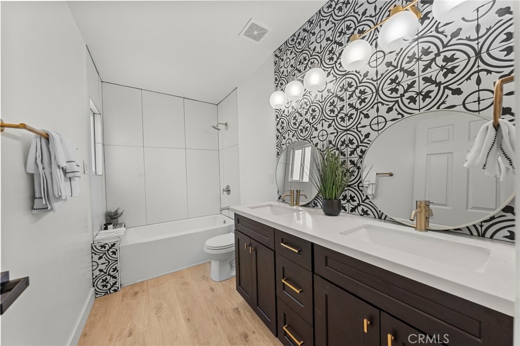 4881 Arlington Avenue Riverside, CA 92504 - Photo 28 of 37 a spacious bathroom with a sink and a mirror