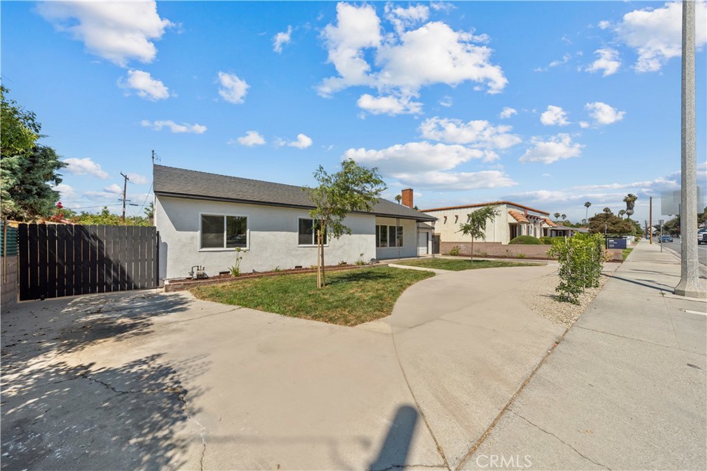 4881 Arlington Avenue Riverside, CA 92504 - Photo 4 of 37 a front view of a house with a yard and garage