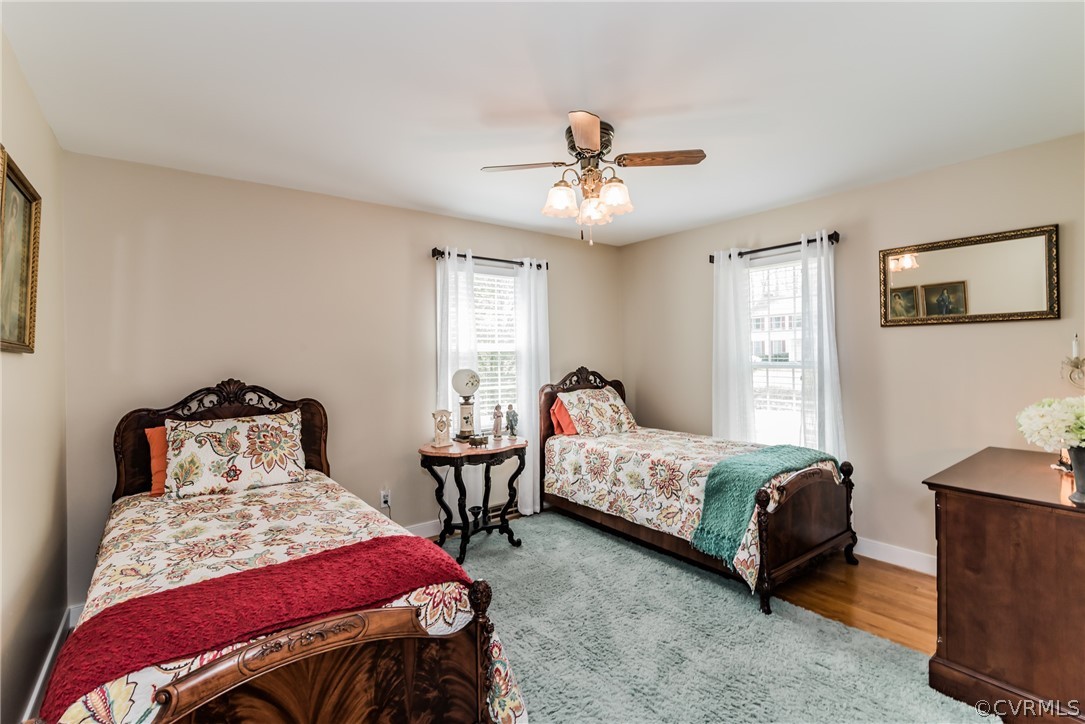 4401 Dunraven Road Chesterfield, VA 23236 - Photo 24 of 35 a bedroom with two beds and a chandelier