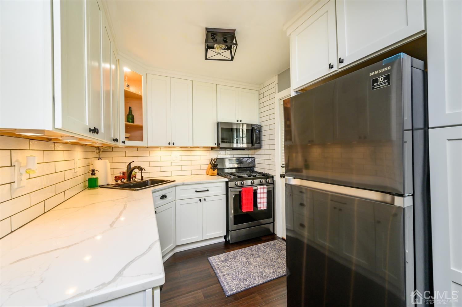 420 Cross Road, Unit B3 Matawan, NJ 07747 - Photo 11 of 24 a kitchen with a refrigerator a sink and a stove