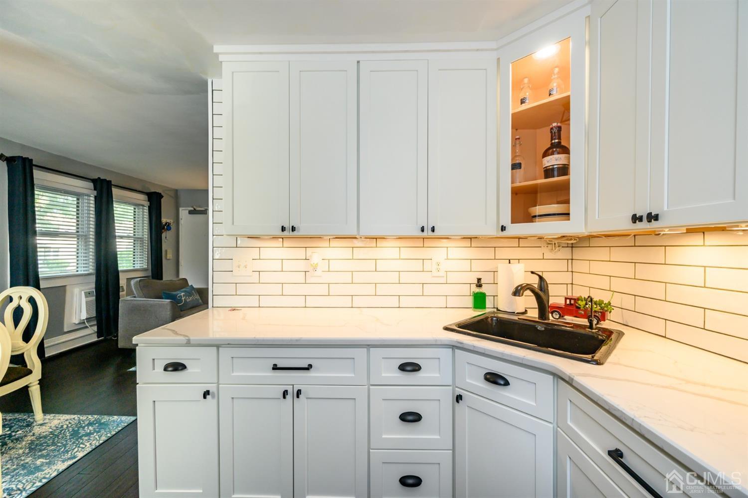 420 Cross Road, Unit B3 Matawan, NJ 07747 - Photo 12 of 24 a kitchen with stainless steel appliances granite countertop a sink a stove and cabinets