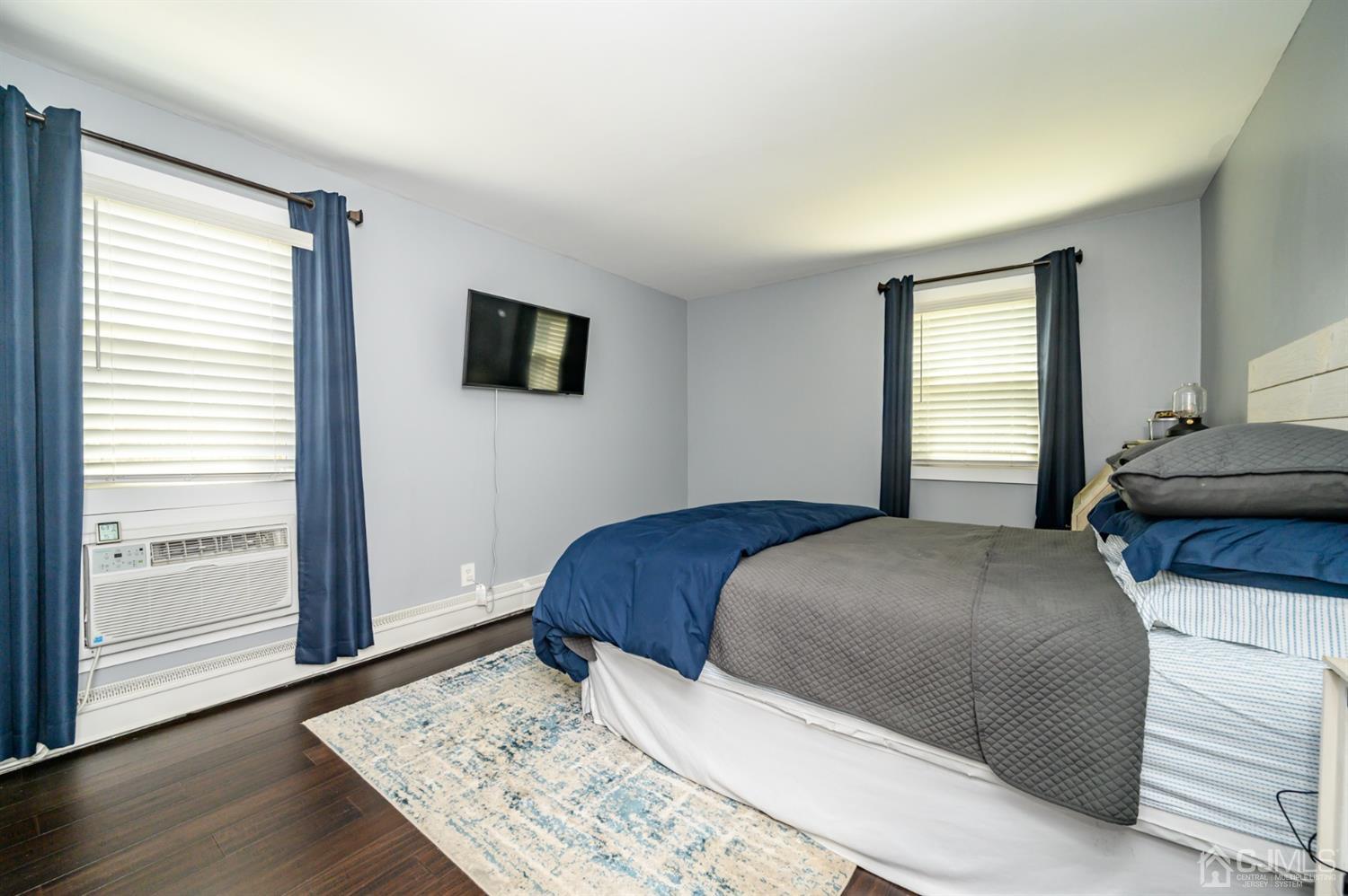 420 Cross Road, Unit B3 Matawan, NJ 07747 - Photo 15 of 24 a bedroom with a large bed and a flat screen tv