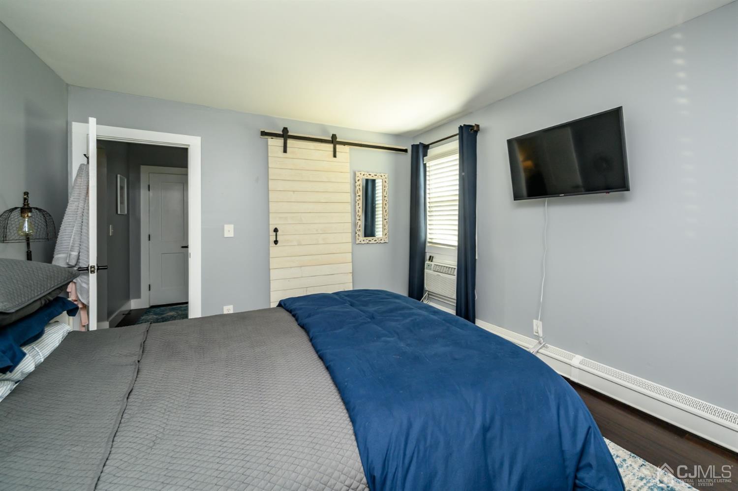 420 Cross Road, Unit B3 Matawan, NJ 07747 - Photo 17 of 24 a bedroom with a bed and a flat screen tv