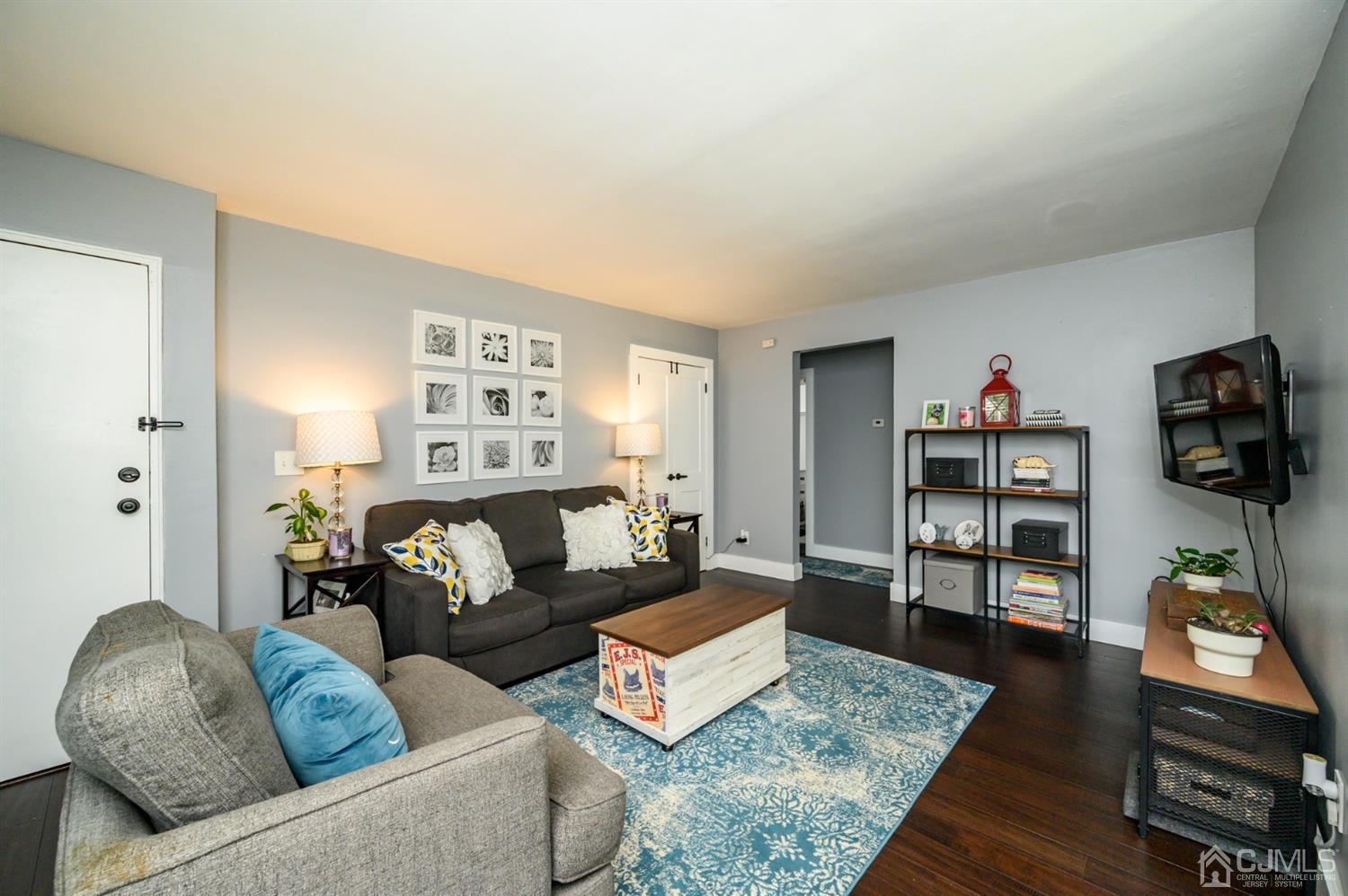 420 Cross Road, Unit B3 Matawan, NJ 07747 - Photo 5 of 24 a living room with furniture and a flat screen tv