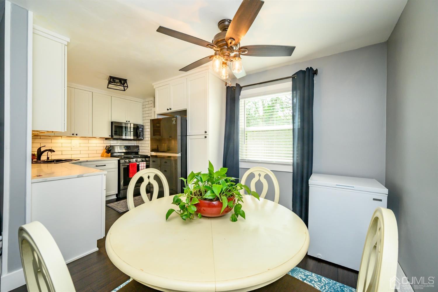 420 Cross Road, Unit B3 Matawan, NJ 07747 - Photo 8 of 24 a view of a dining room with furniture window and wooden floor