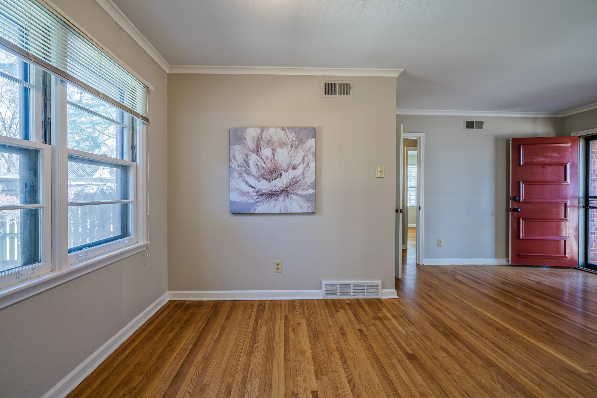 4882 Flamingo Road Memphis, TN 38117 - Photo 9 of 25 a view of an empty room with wooden floor and a window