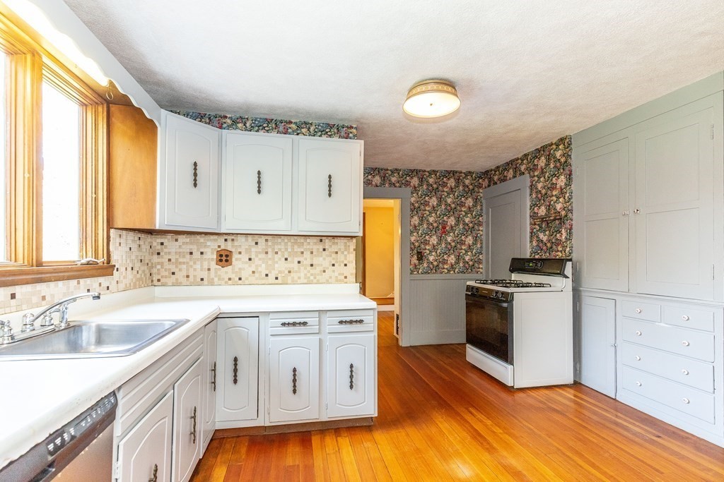 600 Springs Road Bedford, MA 01730 - Photo 11 of 38 a kitchen with a sink cabinets stainless steel appliances and a window