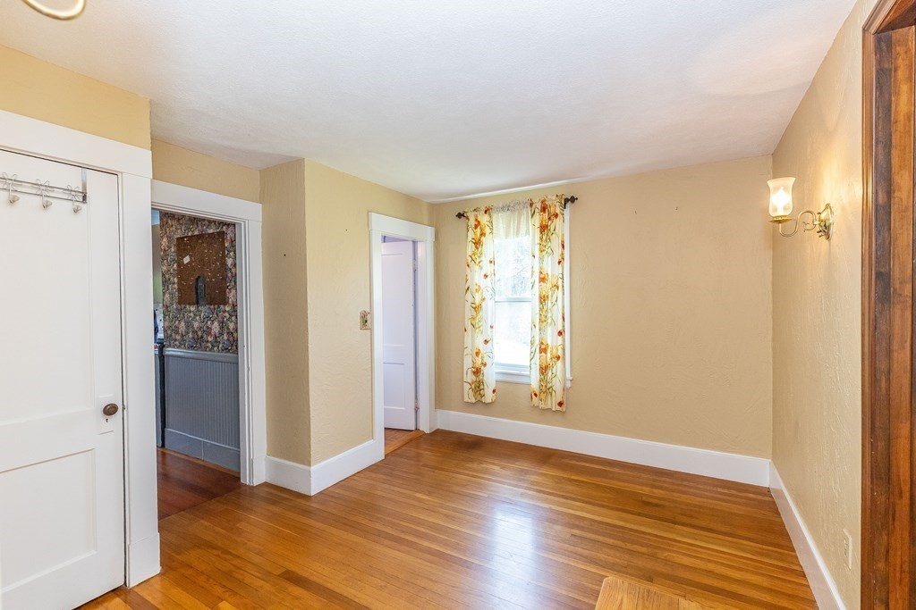 600 Springs Road Bedford, MA 01730 - Photo 19 of 38 a view of an empty room with wooden floor and a window