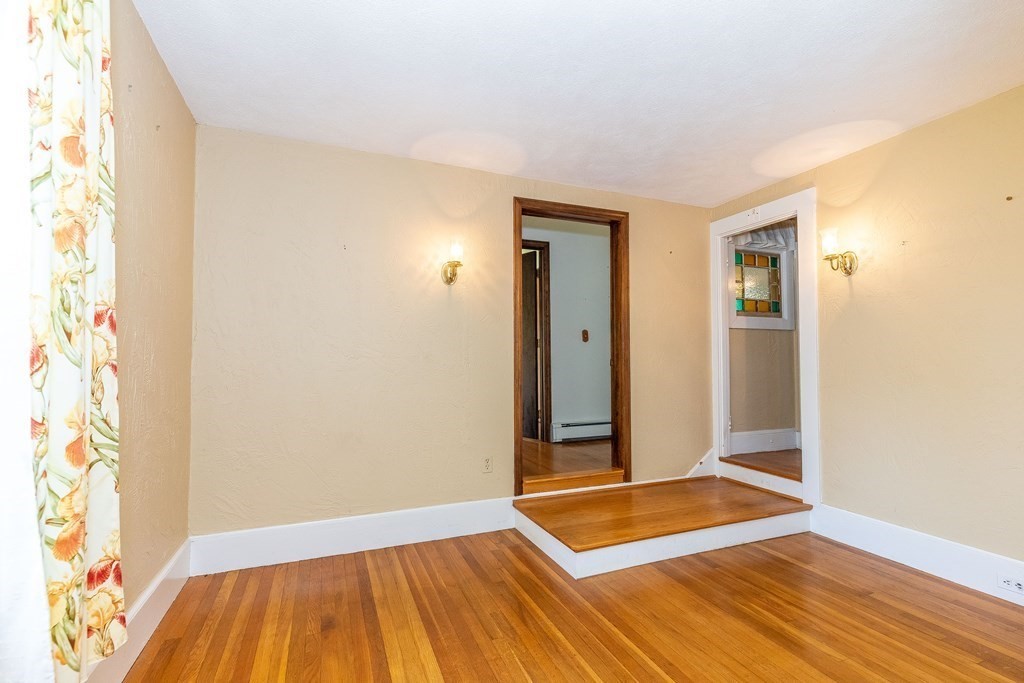 600 Springs Road Bedford, MA 01730 - Photo 20 of 38 a view of an empty room with wooden floor and a window