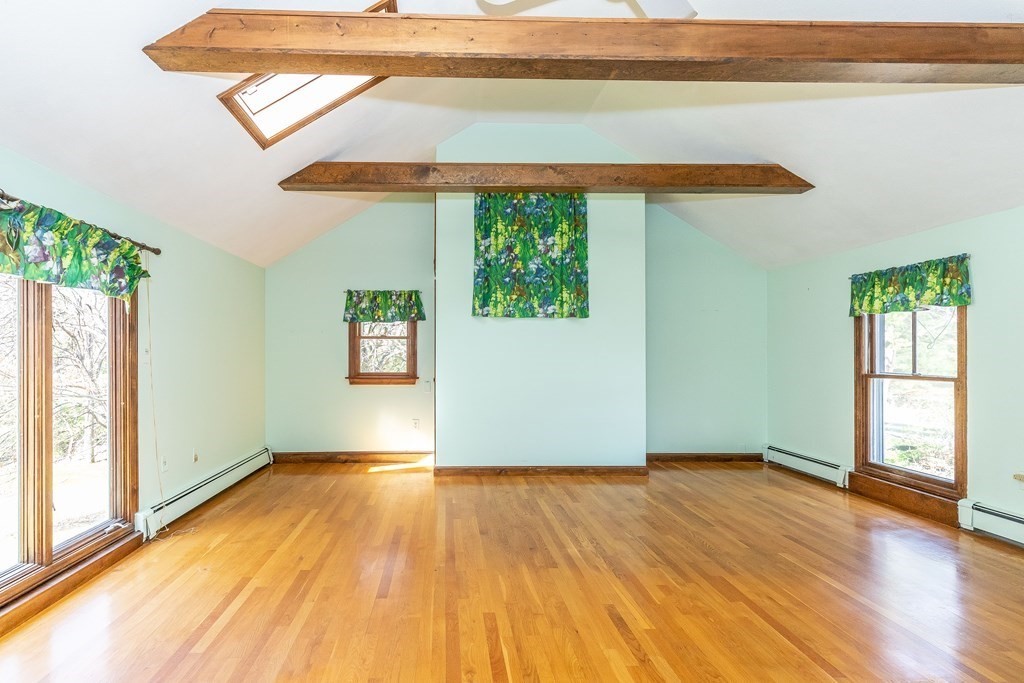 600 Springs Road Bedford, MA 01730 - Photo 27 of 38 an empty room with wooden floor and windows