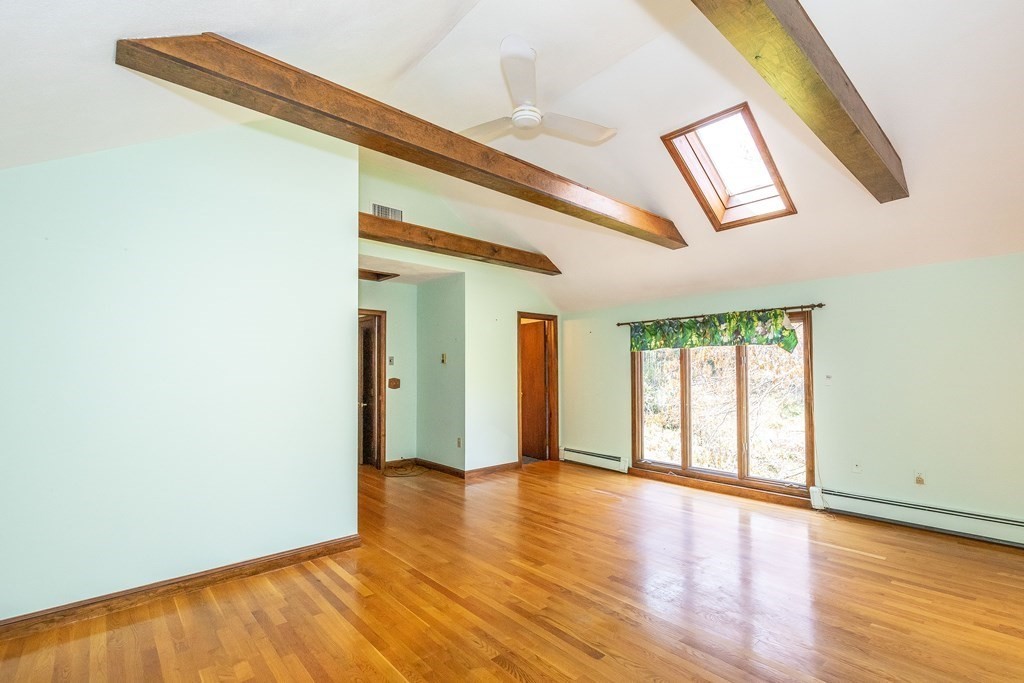 600 Springs Road Bedford, MA 01730 - Photo 28 of 38 an empty room with wooden floor and windows