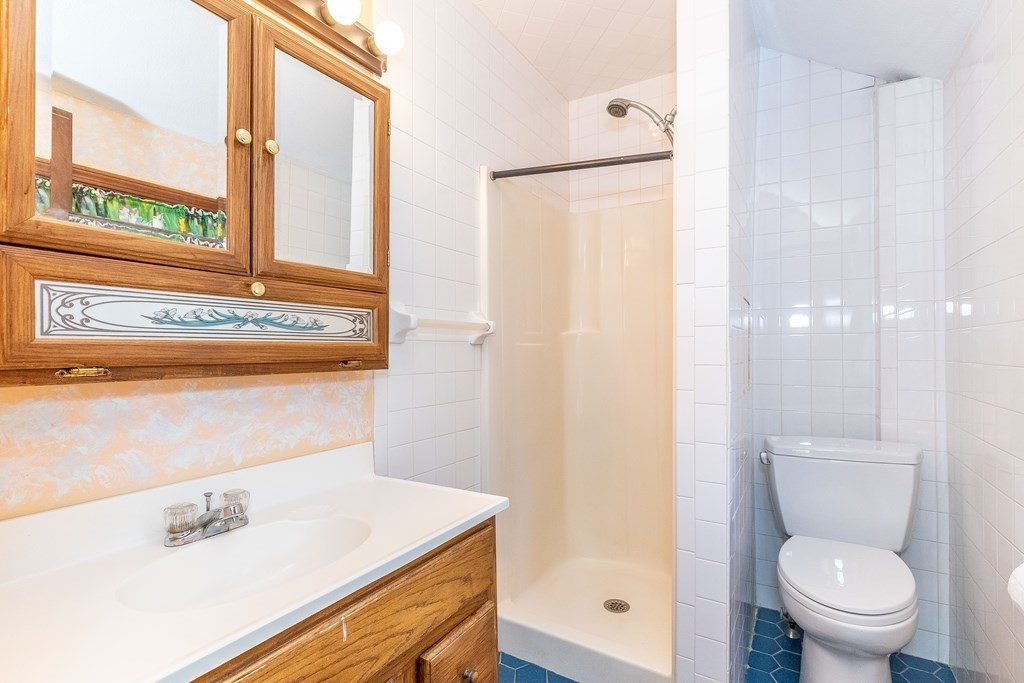 600 Springs Road Bedford, MA 01730 - Photo 29 of 38 a bathroom with a sink toilet and shower
