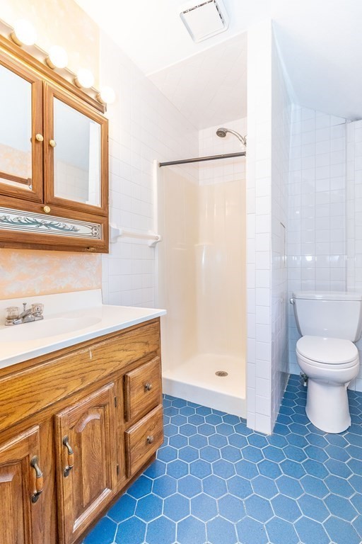 600 Springs Road Bedford, MA 01730 - Photo 30 of 38 a bathroom with a sink a toilet and a mirror