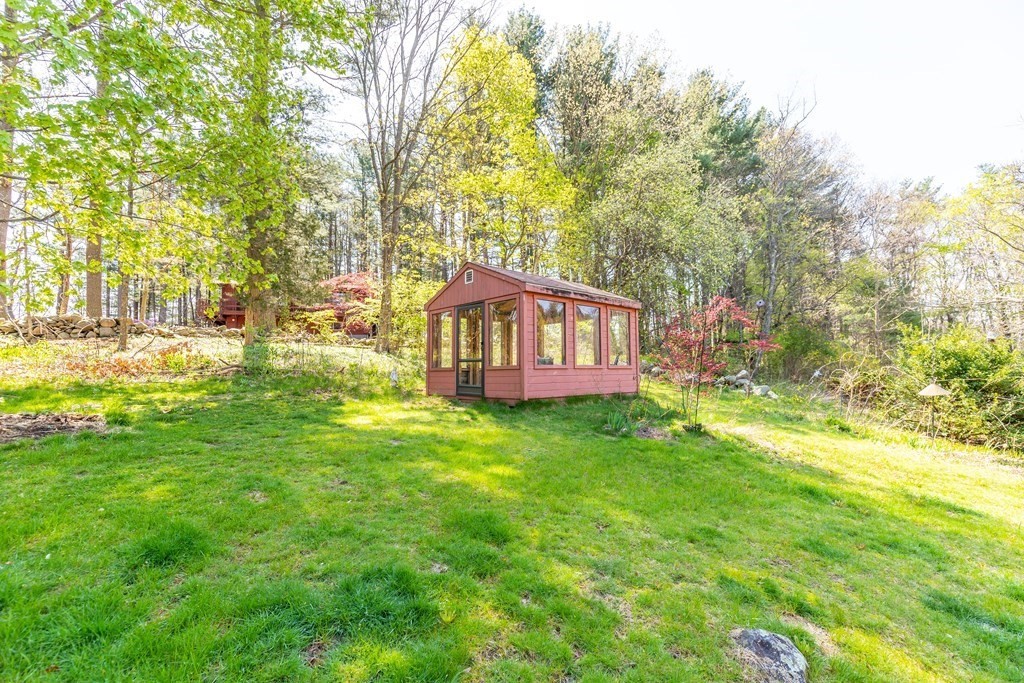 600 Springs Road Bedford, MA 01730 - Photo 5 of 38 a backyard of a house with lots of green space and outdoor seating