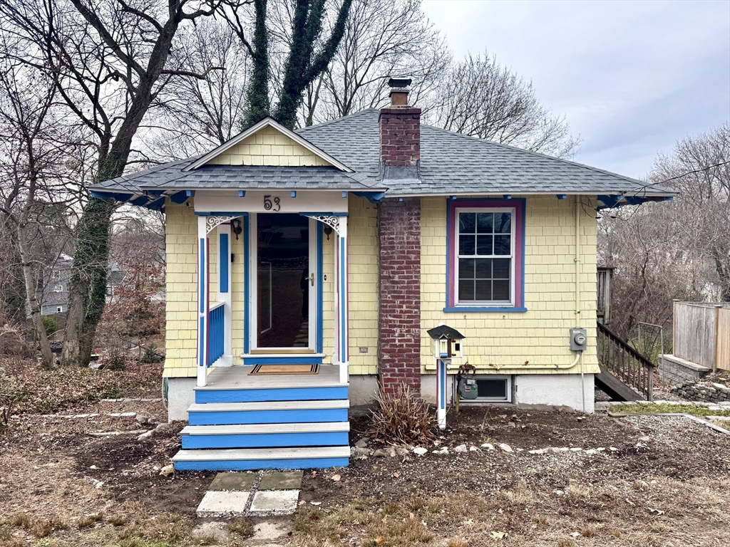 53 Circuit Road Dedham, MA 02026 - Photo 1 of 26 a front view of a house with a bench